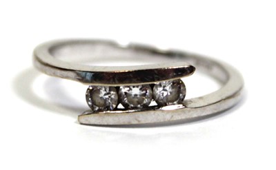 Lot 652 - An 18ct white gold ring set three clear paste...
