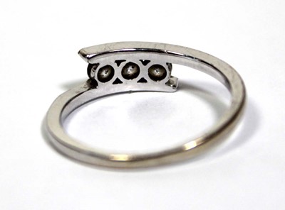 Lot 652 - An 18ct white gold ring set three clear paste...