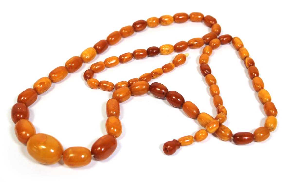 Lot 655 - An amber type single strand graduated bead...