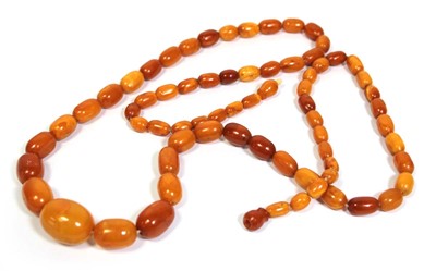 Lot 655 - An amber type single strand graduated bead...