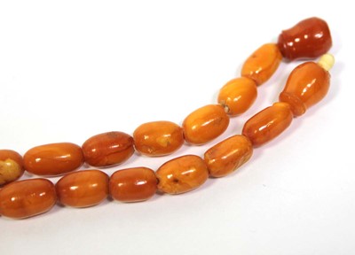 Lot 655 - An amber type single strand graduated bead...