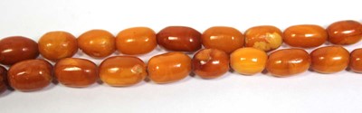 Lot 655 - An amber type single strand graduated bead...