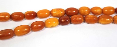 Lot 655 - An amber type single strand graduated bead...