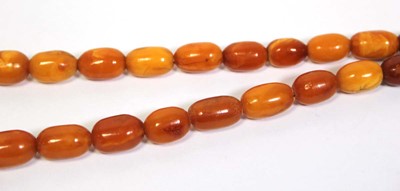Lot 655 - An amber type single strand graduated bead...