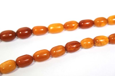 Lot 655 - An amber type single strand graduated bead...
