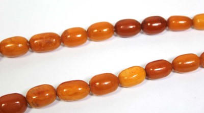 Lot 655 - An amber type single strand graduated bead...