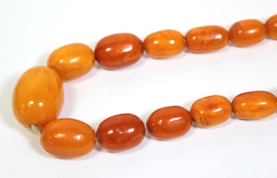 Lot 655 - An amber type single strand graduated bead...