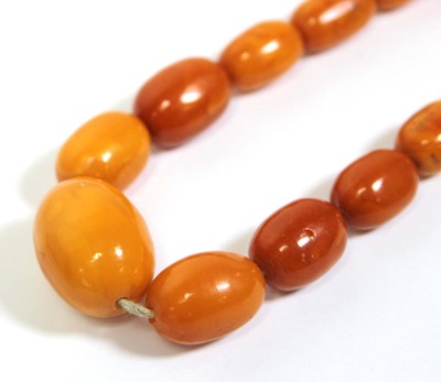 Lot 655 - An amber type single strand graduated bead...