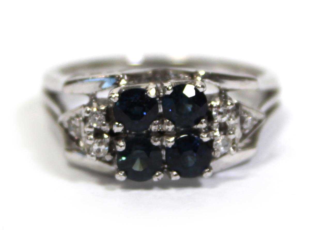 Lot 659 - An 18ct white gold ring set four small...