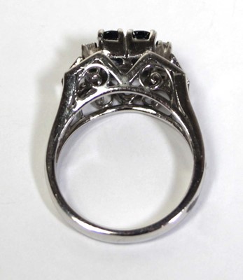 Lot 659 - An 18ct white gold ring set four small...