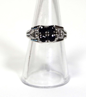 Lot 659 - An 18ct white gold ring set four small...