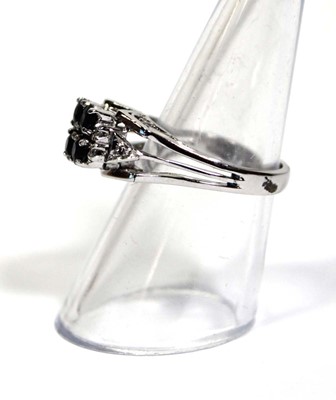 Lot 659 - An 18ct white gold ring set four small...