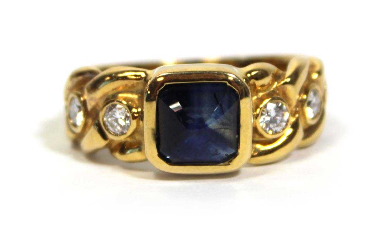 Lot 660 - An 18ct yellow gold ring set cabochon sapphire...