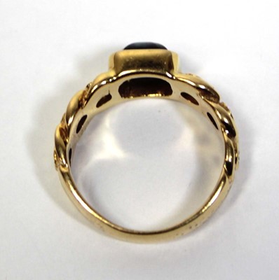 Lot 660 - An 18ct yellow gold ring set cabochon sapphire...
