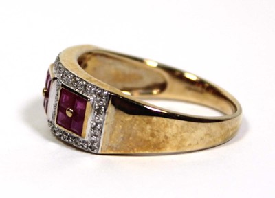 Lot 661 - A 9ct yellow gold ring set three ruby clusters...