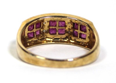 Lot 661 - A 9ct yellow gold ring set three ruby clusters...