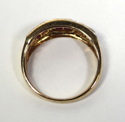 Lot 661 - A 9ct yellow gold ring set three ruby clusters...