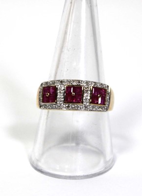 Lot 661 - A 9ct yellow gold ring set three ruby clusters...