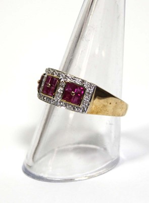 Lot 661 - A 9ct yellow gold ring set three ruby clusters...