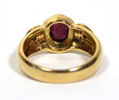 Lot 662 - A 18ct yellow gold ring set oval ruby in a...
