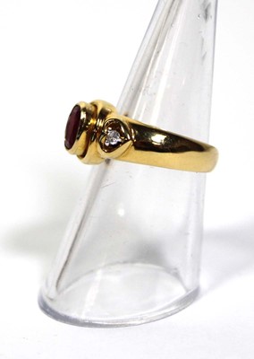 Lot 662 - A 18ct yellow gold ring set oval ruby in a...