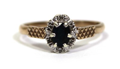 Lot 666 - A 9ct yellow gold cluster ring set oval...