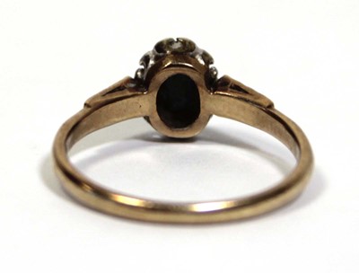 Lot 666 - A 9ct yellow gold cluster ring set oval...
