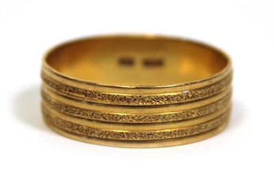 Lot 670 - A 22ct yellow gold textured wedding band, band...