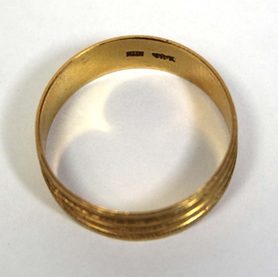 Lot 670 - A 22ct yellow gold textured wedding band, band...