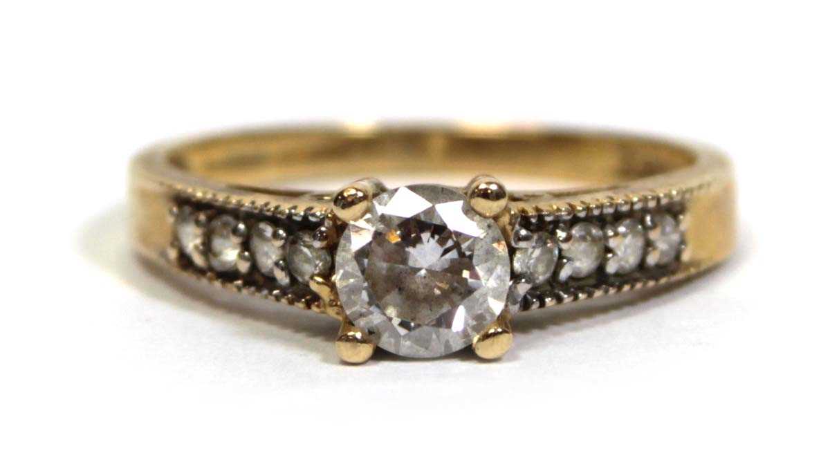 Lot 672 - A 14ct yellow gold ring set cubic zirconia,...