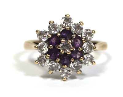 Lot 673 - A 9ct yellow gold cluster ring set clear and...