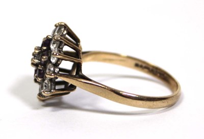 Lot 673 - A 9ct yellow gold cluster ring set clear and...