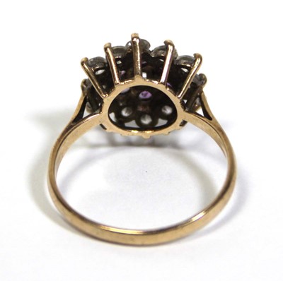 Lot 673 - A 9ct yellow gold cluster ring set clear and...