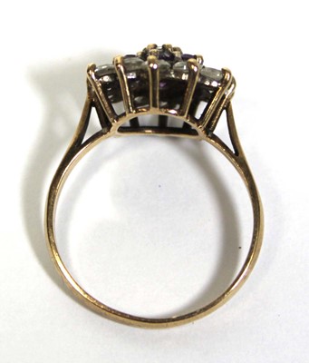 Lot 673 - A 9ct yellow gold cluster ring set clear and...