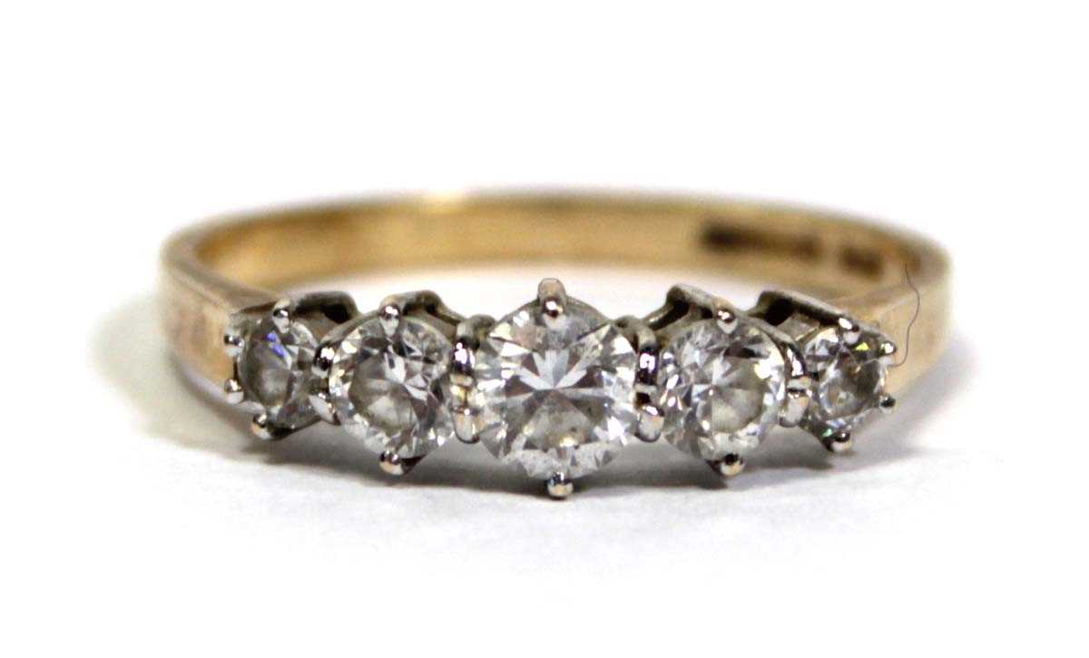 Lot 675 - A 14ct yellow gold ring set five graduated...