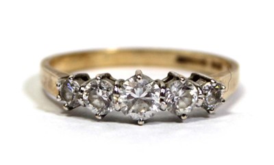 Lot 675 - A 14ct yellow gold ring set five graduated...