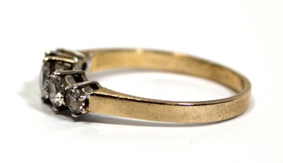 Lot 675 - A 14ct yellow gold ring set five graduated...