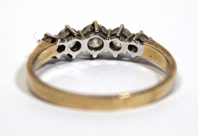 Lot 675 - A 14ct yellow gold ring set five graduated...