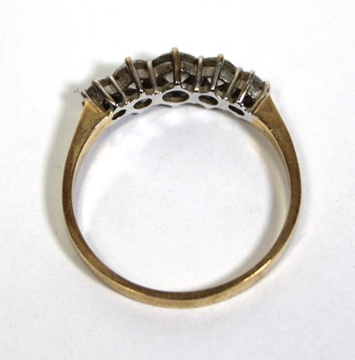 Lot 675 - A 14ct yellow gold ring set five graduated...