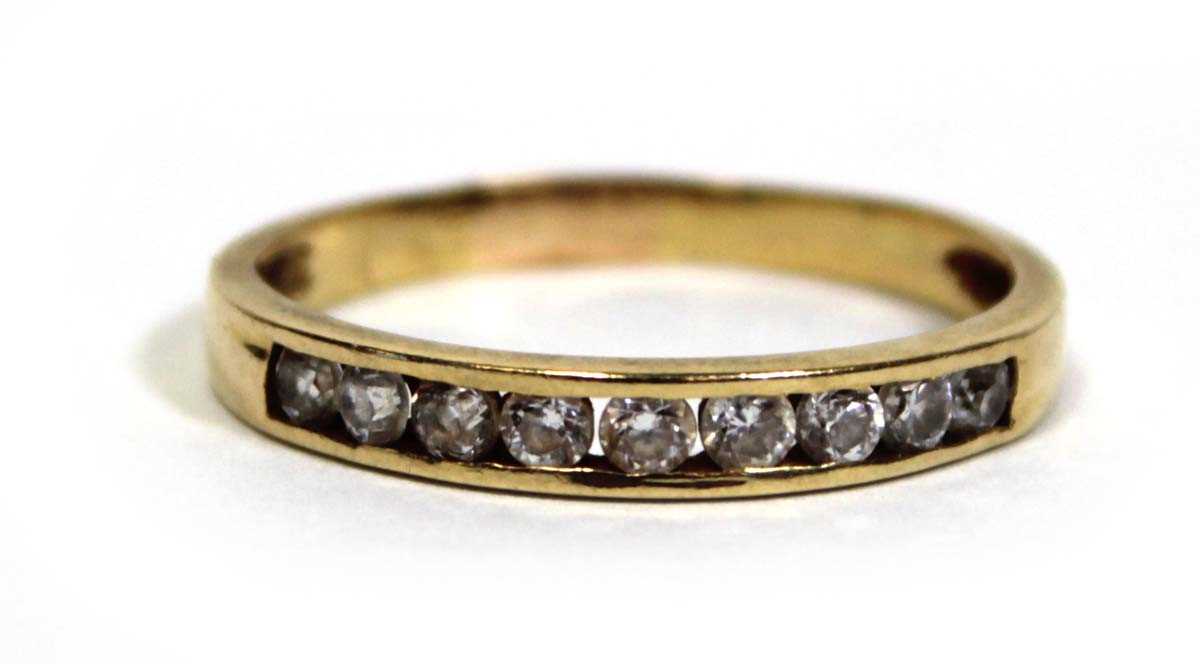 Lot 676 - A yellow metal half eternity ring set paste in...