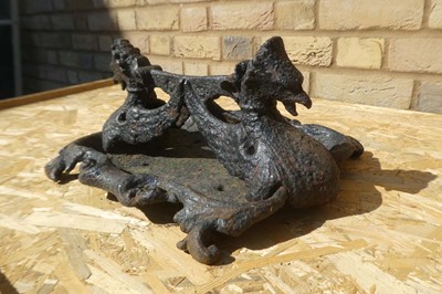 Lot A cast iron twin headed griffin themed boot...