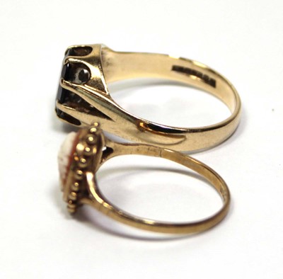 Lot 686 - A 9ct yellow gold ring set oval garnet in an...