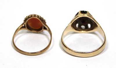 Lot 686 - A 9ct yellow gold ring set oval garnet in an...