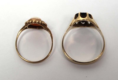 Lot 686 - A 9ct yellow gold ring set oval garnet in an...