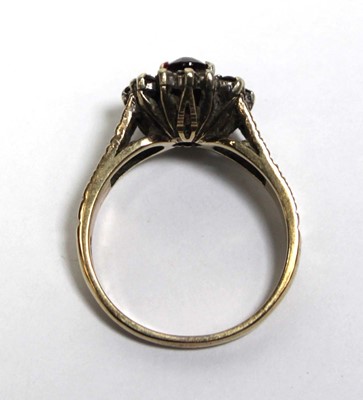 Lot 687 - A 9ct yellow gold cluster ring set oval garnet...