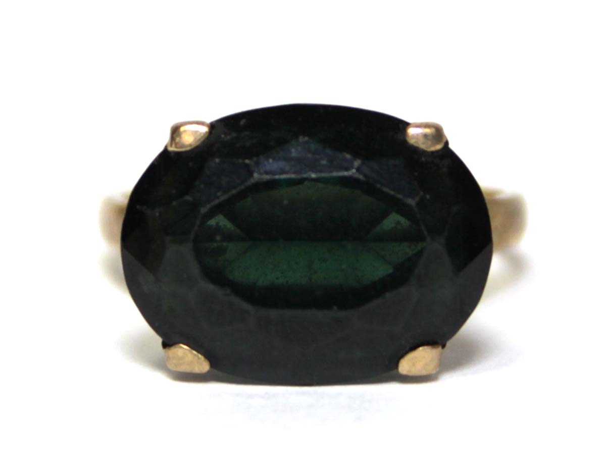 Lot 688 - A 9ct yellow gold dress ring set oval green...