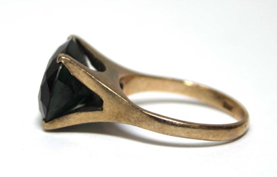 Lot 688 - A 9ct yellow gold dress ring set oval green...