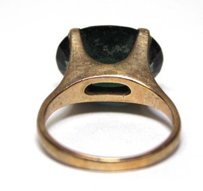 Lot 688 - A 9ct yellow gold dress ring set oval green...
