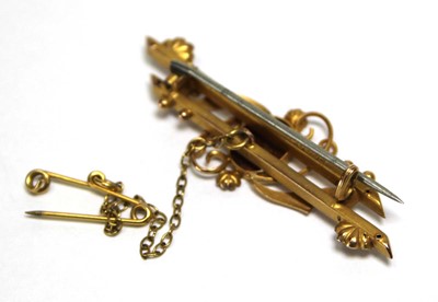 Lot 695 - An Edwardian 9ct yellow gold bar brooch set...