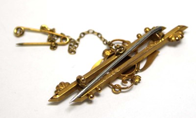 Lot 695 - An Edwardian 9ct yellow gold bar brooch set...
